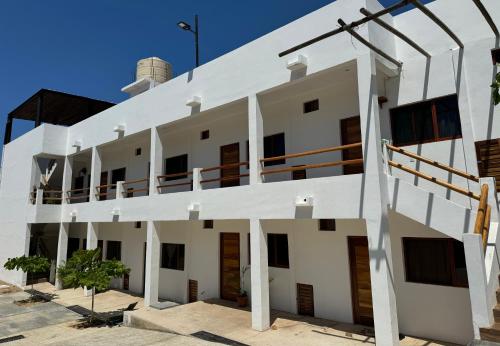 a large white building with a balcony at Casa Mura in Puerto Escondido