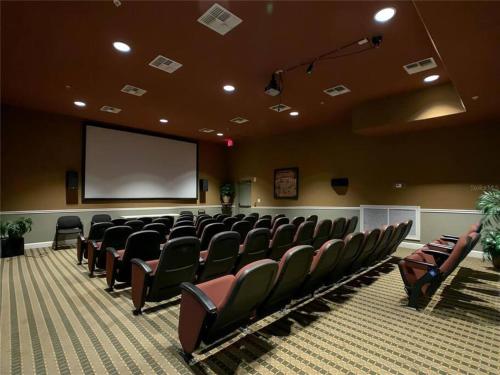 a conference room with chairs and a projection screen at Lux 4BrVilla Hot Tub Grill Private Heated Pool in Kissimmee