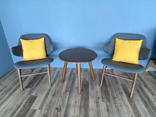 two chairs and a table with a yellow pillow at The Podium-Studio-Free 1 Parking-6 Pax-D321B in Kuching