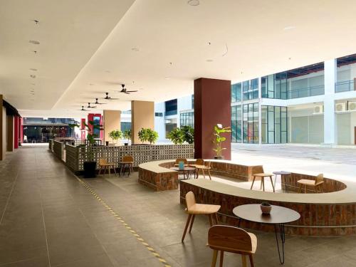a lobby with tables and chairs in a building at The Podium-Studio-Free 1 Parking-6 Pax-D321B in Kuching