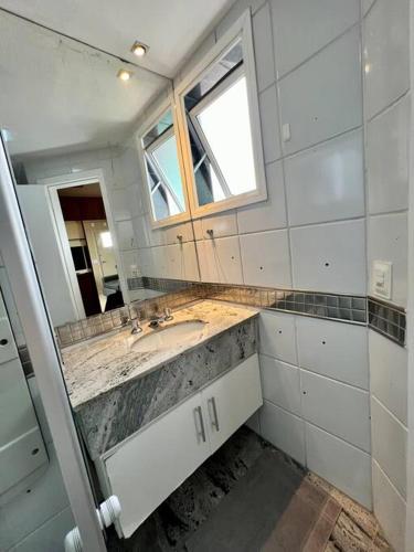 a bathroom with a sink and a mirror at Renoir - Av Barão Homem de Melo nº 4520 - pegar nº do flat no chat após reserva in Belo Horizonte