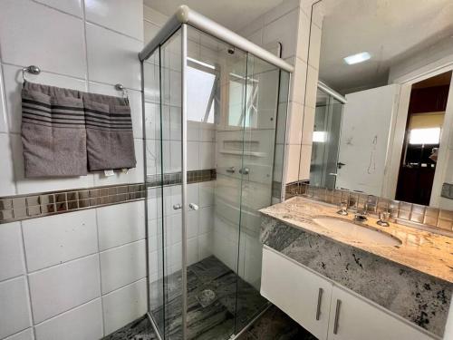 a bathroom with a glass shower and a sink at Renoir - Av Barão Homem de Melo nº 4520 - pegar nº do flat no chat após reserva in Belo Horizonte