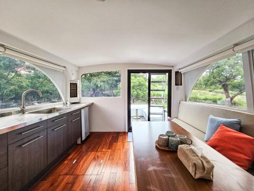 a kitchen with a couch and a large window at 墾丁圓石灘 Kenting Pebble Beach in Fangshan