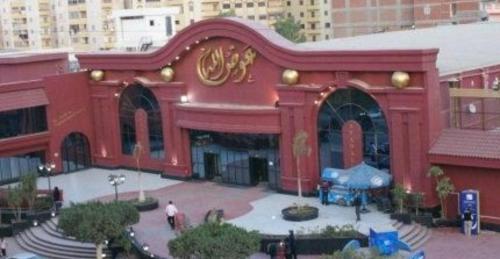 a large red building with people standing outside of it at El mansoura Heaven in Bandar al Manşūrah
