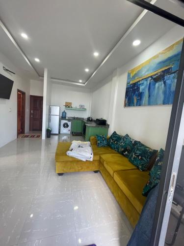 a living room with a couch and a kitchen at Apex Boutique apartments in Georgetown