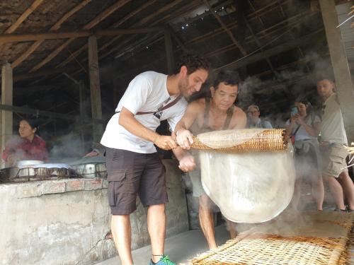 a couple of men preparing a largeiameteriameteriameteriameter at WELKOM INN in Can Tho