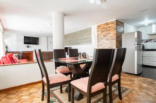 a kitchen and dining room with a table and chairs at CASA FLORES in Bogotá