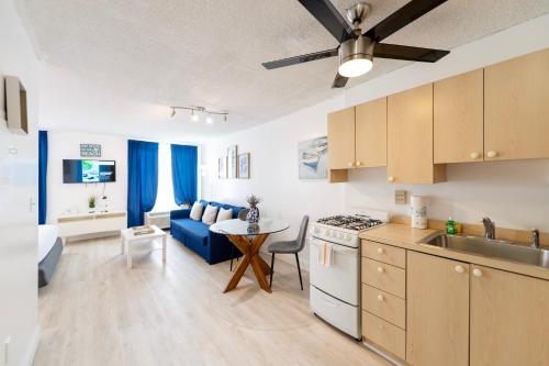 a kitchen and living room with a couch and a table at South Beach Apartments in Miami Beach