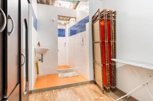 a bathroom with a sink and a toilet in a room at CASA FLORES in Bogotá