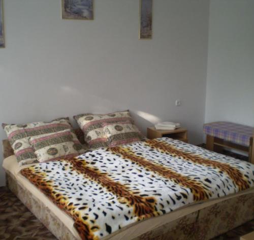 a bed in a room with two pillows on it at Jartó Apartman in Harkány