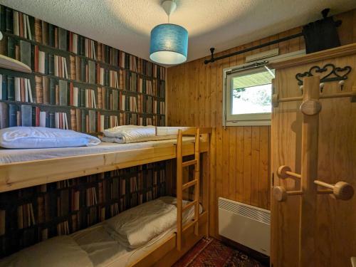 a room with a bunk bed and bookshelves at Appartement La Clusaz, 3 pièces, 6 personnes - FR-1-459-211 in La Clusaz
