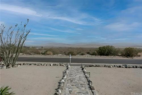 a road in the middle of the desert at View Joshua Tree from the Desert D-LUX in Twentynine Palms