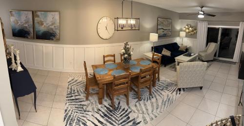 a dining room and living room with a table and chairs at Ocean Walk Beach and Sun New Smyrna Beach in New Smyrna Beach