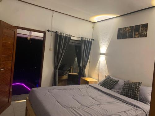 a bedroom with a bed and a window at Tukadsari camping in Kintamani