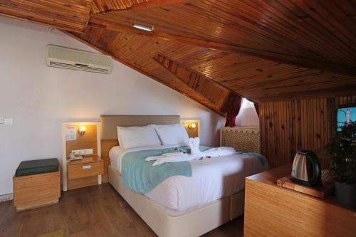 a bedroom with a large bed in a room at Turkuaz Boutique Hotel in Buyukcekmece