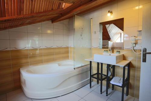 a bathroom with a tub and a sink at Turkuaz Boutique Hotel in Buyukcekmece