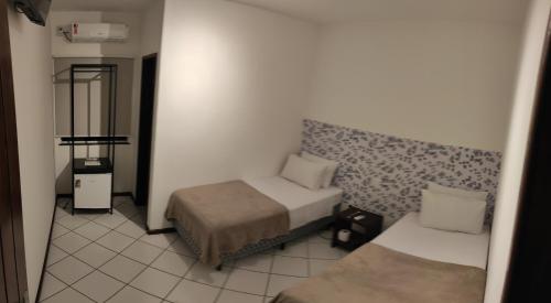 Кровать или кровати в номере Pousada Jardins - Mar Grande
