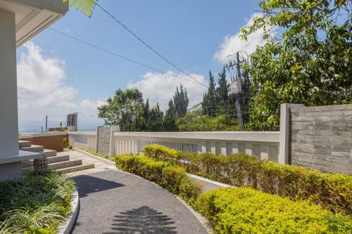 a walkway in front of a house with a fence at Lavender - Taman Tanda in Bedugul