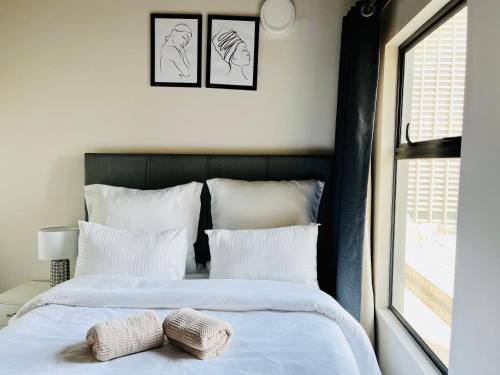 a bedroom with two beds with white sheets and pillows at Skyline Serenade in Johannesburg