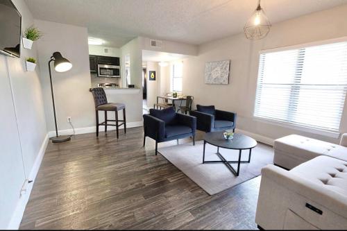 a living room with a couch and a table at Global Cup Dallas Urban Comfort and Arboretum Tickets in Dallas