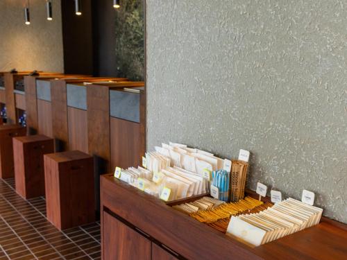 a restaurant with a counter with a bunch of food at The Royal Park Canvas Fukuoka Nakasu in Fukuoka