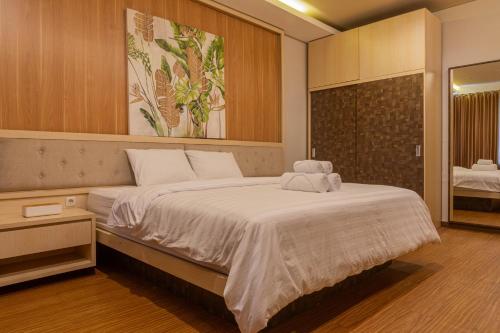 a bedroom with a large bed with a towel on it at Lavender - Taman Tanda in Bedugul