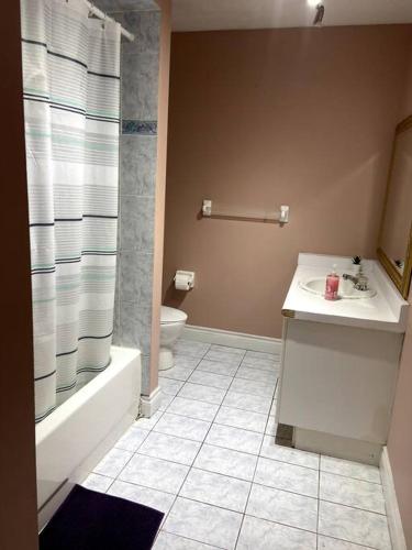 a bathroom with a sink and a toilet and a shower at Room for Rent Room 1 in Brampton