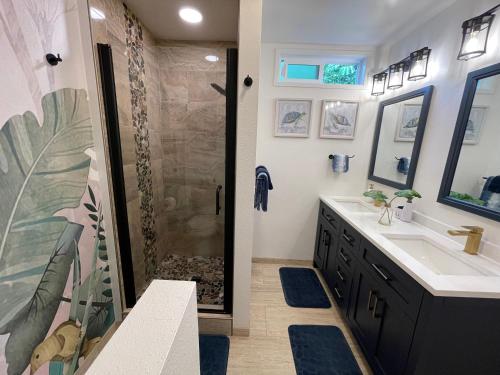 a bathroom with a shower and a sink at Hale O Malu at Kaloli Point in Keaau