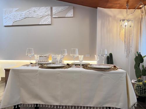 a white table with wine glasses on top of it at 台南悠然民宿unabnb in Tainan