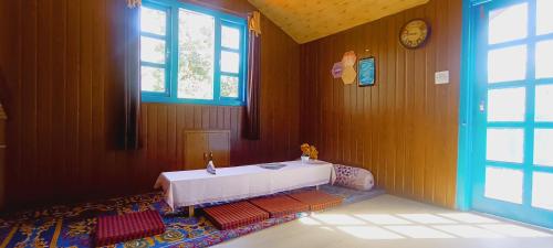 una habitación con una mesa en la esquina de una habitación en The City Escape Farmstay, en Shimla
