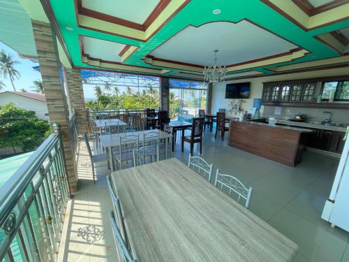 a dining room and kitchen with a table and chairs at Siargao By Grace Suites in General Luna