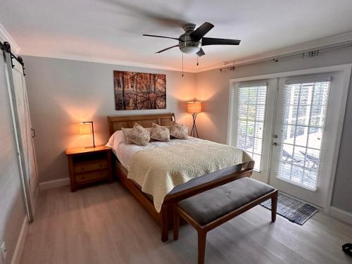 a bedroom with a bed and a ceiling fan at Florida house, 4br 2bt with private pool oasis in Naples