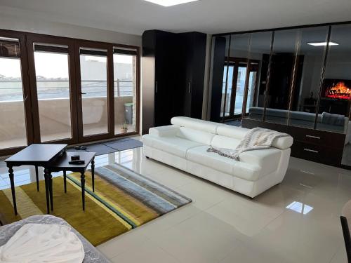 a living room with a white couch and a table at NEW Seaview Bachelor Apartment Privacy + Closets in Mudanya