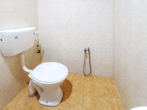 a bathroom with a toilet and a shower at Chalet Yunie Marang by RVH in Kampong Ru Dua