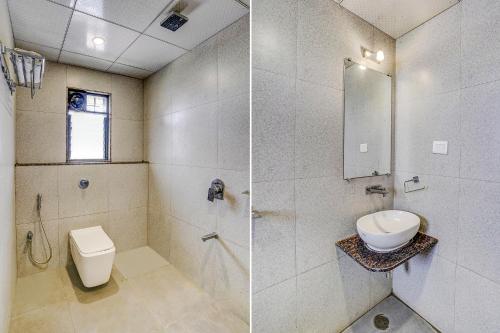 a bathroom with a toilet and a shower and a sink at FabHotel Ansh in Aurangabad
