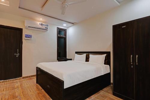 a bedroom with a large bed with white sheets at Super Collection O Oyo Townhouse Lemonade Shyam Nagar in Juhi Bari