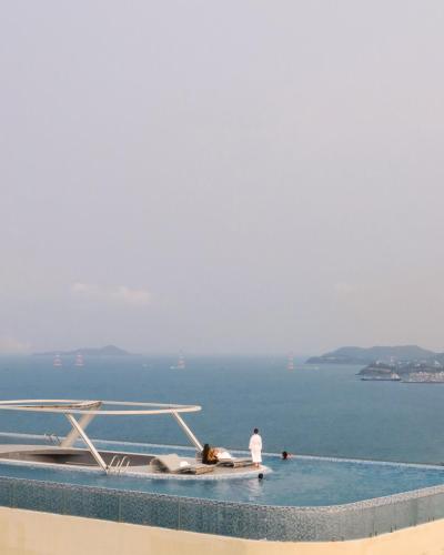 a couple of people in the water in a swimming pool at Grand Tourane Nha Trang Hotel in Nha Trang