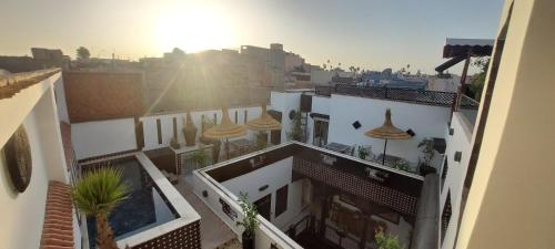a view of a building with the sun in the distance at Dar Najat in Marrakech