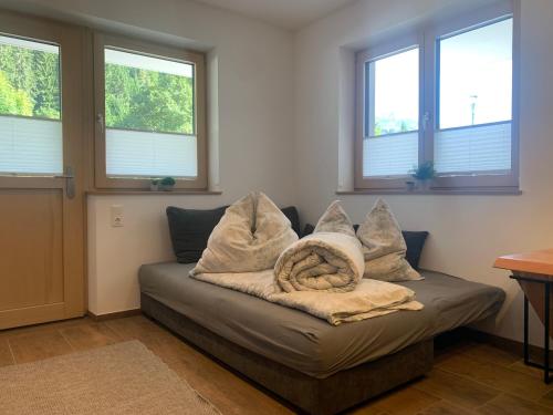 a couch with pillows on it in a room with windows at Appartement Dorfblick in Auffach
