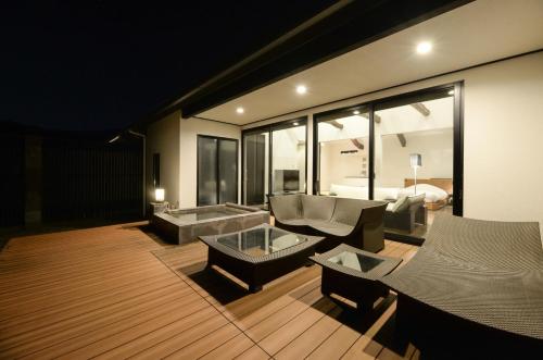 a living room with a couch and a table at Fugaku Gunjo in Izu