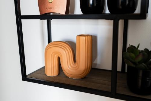 a wooden letter nm on a shelf with wine glasses at Le domaine de la Rhonelle in Villers-Pol