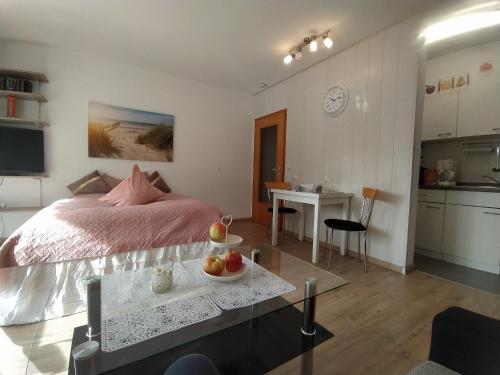 Un dormitorio con una cama y una mesa con fruta. en Appartementhaus Tannenhof - Wohnung 2, en Haidmühle