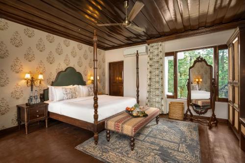 a bedroom with a large bed and a large window at Brij Anayra Dharamshala - A Himalayan Luxury Retreat in Dharamshala
