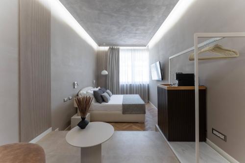 a small bedroom with a bed and a table at Duomo Collection in Milan