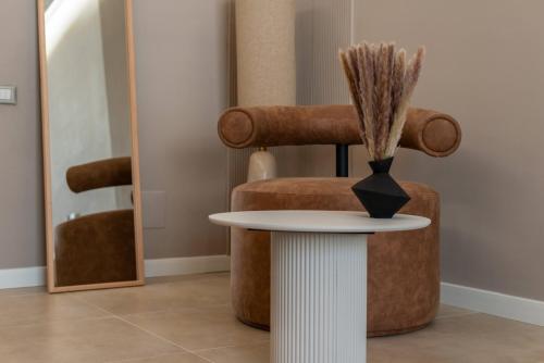 a table with a vase on it next to a chair at Duomo Collection in Milan