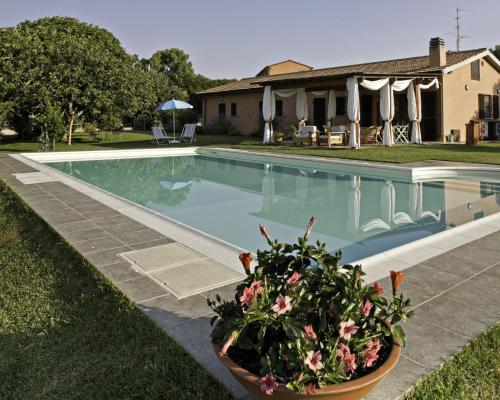 a swimming pool with flowers in a yard at Agriturismo Prati degli Orti in Montiano