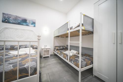 a bedroom with two bunk beds in a room at Il Sogno in Avola