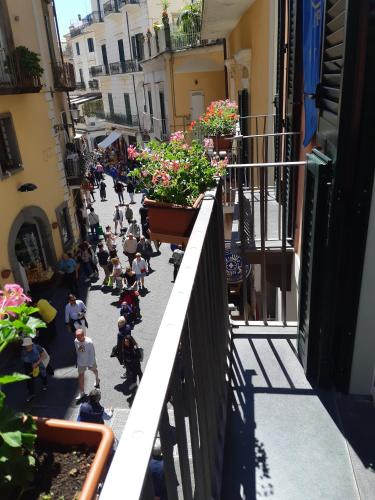 a group of people walking down a street with flowers at ApartHotel Antica Repubblica in Amalfi center at 100mt from the sea in Amalfi