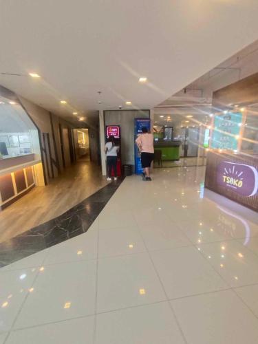 an empty lobby of an airport with people standing in it at Mactan Newtown 2 Bedroom near Mactan Airport in Punta Engaño