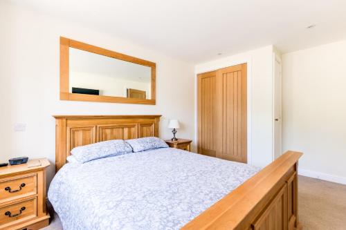 a bedroom with a bed and a mirror on the wall at Chy Pol in Wadebridge